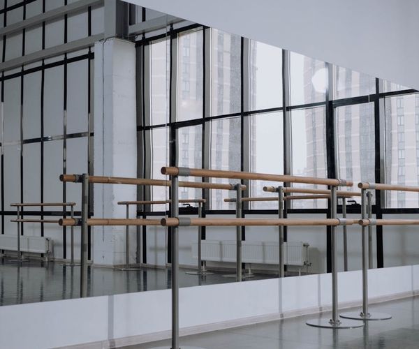 A clean, modern, and empty studio space with ambient lighting, ready for a class.